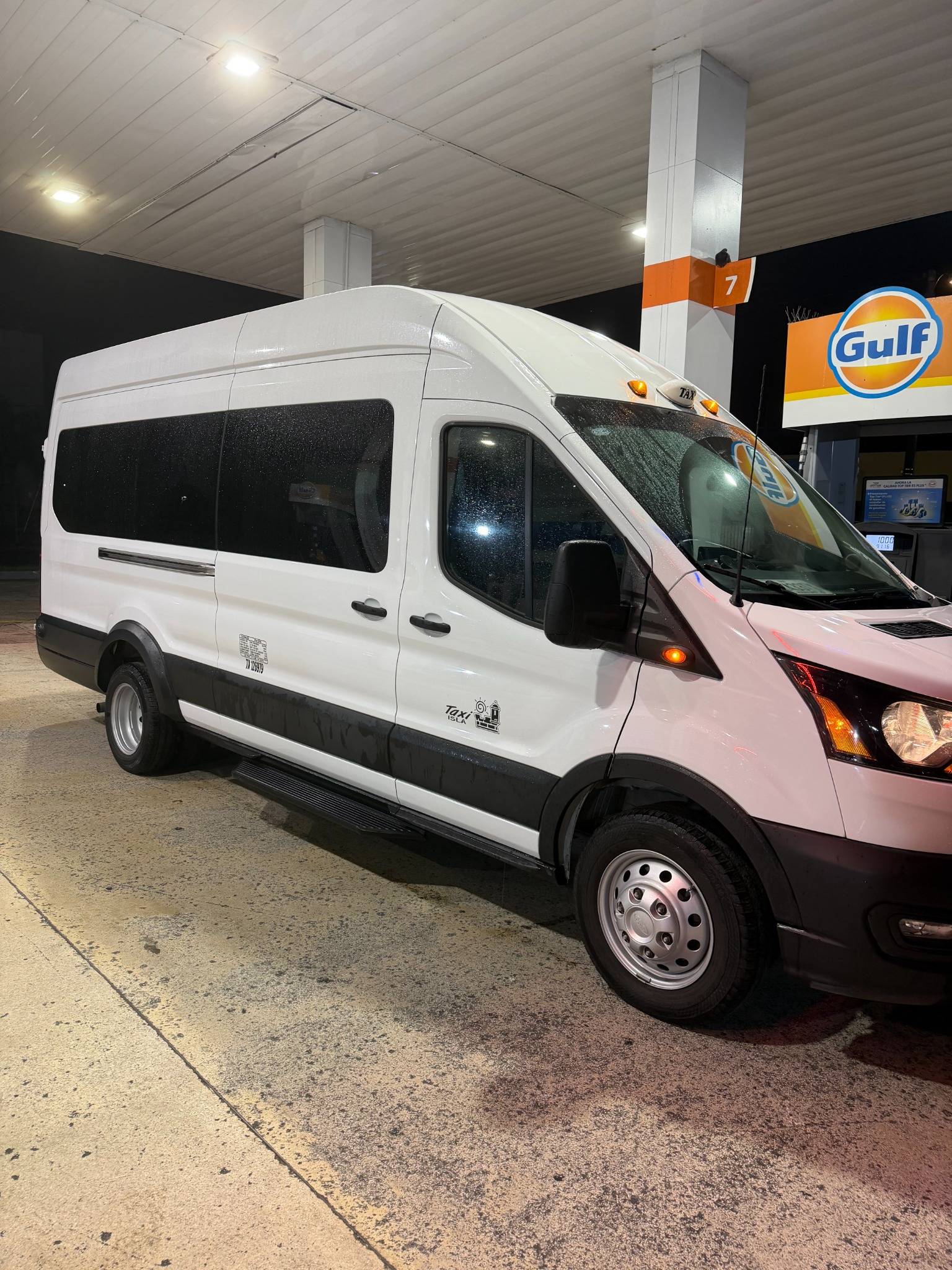 Our white Ford Transit 350 HD passenger van for private transfers between Rincon and San Juan